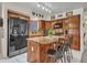 Traditional-style kitchen with wood cabinets, center island with seating, and modern black appliances at 8926 W Lockland Ct, Peoria, AZ 85382