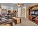 An Open-concept living room with a brick fireplace, dining area and view of kitchen at 8926 W Lockland Ct, Peoria, AZ 85382