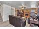 Cozy living room featuring a brick fireplace, a ceiling fan, and comfortable seating at 8926 W Lockland Ct, Peoria, AZ 85382