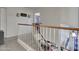 Upstairs hallway and staircase showcasing a decorative banister and neutral decor at 8926 W Lockland Ct, Peoria, AZ 85382