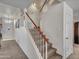 Carpeted staircase with white railings leads to the upper level of the home, bathed in natural light at 8926 W Lockland Ct, Peoria, AZ 85382