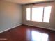 Bright bedroom featuring gleaming wood floors and a large window allowing natural light at 10115 E Mountain View Rd # 1119, Scottsdale, AZ 85258