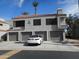 Exterior shot of a two-story townhome featuring a multi-car garage, white car parked in the driveway and red tile roof at 10115 E Mountain View Rd # 1119, Scottsdale, AZ 85258