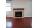 Close-up view of the fireplace with a tile surround and mantle, set against hardwood floors at 10115 E Mountain View Rd # 1119, Scottsdale, AZ 85258