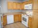 Well-lit kitchen featuring white appliances, light wood cabinets, and neutral countertops at 10115 E Mountain View Rd # 1119, Scottsdale, AZ 85258