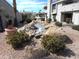 Landscaped water feature with river rock and a small stream, adding to the property's serene and picturesque environment at 10115 E Mountain View Rd # 1119, Scottsdale, AZ 85258