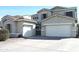 Lovely two-story home features two garages, a gray-tone exterior, and a well-manicured front yard at 10343 E Jacob Ave, Mesa, AZ 85209