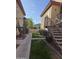 Exterior shot showcases a manicured lawn, sidewalk, and stairs leading to upper units at 10410 N Cave Creek Rd # 1103, Phoenix, AZ 85020