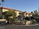 Exterior shot showcases lush landscaping, a water fountain, and ample parking in a well-maintained community at 10410 N Cave Creek Rd # 1103, Phoenix, AZ 85020