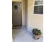 Inviting entryway featuring a brown door, welcoming mat, unit number, and a potted red flowering plant at 10410 N Cave Creek Rd # 1103, Phoenix, AZ 85020