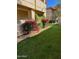 Lush green landscaping featuring vibrant pink flowers and manicured bushes surrounding a modern building at 10410 N Cave Creek Rd # 1103, Phoenix, AZ 85020