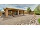 Spacious backyard featuring a covered patio, gravel landscape, a rock border, and a privacy fence at 1066 E Sourwood Dr, Gilbert, AZ 85298