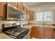 Close-up of a modern kitchen showcasing stainless steel appliances, including a range and microwave above at 1066 E Sourwood Dr, Gilbert, AZ 85298