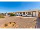 The spacious backyard features desert landscaping and a covered patio at 10846 W Sun City Blvd, Sun City, AZ 85351