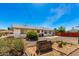 View of the house from the backyard with lots of desert landscaping and a block fence at 10846 W Sun City Blvd, Sun City, AZ 85351