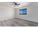 Bright bedroom featuring wood-look floors, white walls, and a window offering scenic outdoor views at 10846 W Sun City Blvd, Sun City, AZ 85351