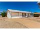 Single-story home with a xeriscaped front yard, attached garage, and concrete driveway at 10846 W Sun City Blvd, Sun City, AZ 85351