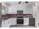 Well-lit kitchen with stainless steel appliances and white cabinetry offers a modern aesthetic at 10846 W Sun City Blvd, Sun City, AZ 85351