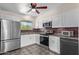 Modern kitchen with stainless steel appliances, stylish backsplash, and tile flooring at 10846 W Sun City Blvd, Sun City, AZ 85351