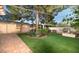 Landscaped backyard with brick-lined path and mature shade trees at 1261 E Edgemont Ave, Phoenix, AZ 85006