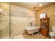 Luxurious bathroom featuring a freestanding tub and tiled shower at 1261 E Edgemont Ave, Phoenix, AZ 85006