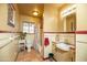 Classic bathroom with a bathtub, tiled walls, and vintage fixtures at 1261 E Edgemont Ave, Phoenix, AZ 85006