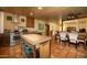 Kitchen with stainless steel appliances, terracotta tile floor, dining area, and island at 1261 E Edgemont Ave, Phoenix, AZ 85006