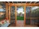 Screened porch with brick flooring offering a view of the backyard at 1261 E Edgemont Ave, Phoenix, AZ 85006