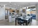 Open dining area with a kitchen island, stainless steel appliances, and a view to the patio at 14254 W Cottontail Ln, Surprise, AZ 85387