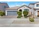 Charming single-story home with a two-car garage, desert landscaping, and neutral tones at 14254 W Cottontail Ln, Surprise, AZ 85387