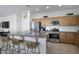 Modern kitchen with stainless steel appliances, a granite countertop island, and stylish seating at 14254 W Cottontail Ln, Surprise, AZ 85387