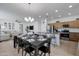 Open concept kitchen and dining area with modern appliances, a kitchen island and ample space at 14254 W Cottontail Ln, Surprise, AZ 85387