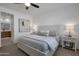 Serene main bedroom featuring a large bed, neutral decor, and ample natural light at 14254 W Cottontail Ln, Surprise, AZ 85387