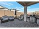 Cozy outdoor patio with comfortable seating, a grill, and a privacy wall at 14254 W Cottontail Ln, Surprise, AZ 85387