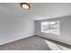 Well lit room featuring neutral paint, carpet, and a window view of the backyard at 148 N Glenview --, Mesa, AZ 85213