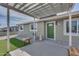 Inviting front entrance featuring a covered patio with decorative seating and a well-manicured lawn at 148 N Glenview --, Mesa, AZ 85213