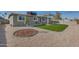 Inviting home with decorative landscaping featuring an easy-to-maintain desert rock and a small patch of grass at 148 N Glenview --, Mesa, AZ 85213