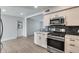 Well-lit kitchen featuring stainless steel appliances, subway tile backsplash, and white cabinetry at 148 N Glenview --, Mesa, AZ 85213