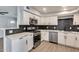 Renovated kitchen featuring stainless steel appliances, white cabinets, and modern countertops at 148 N Glenview --, Mesa, AZ 85213