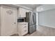 Pantry access in kitchen with stainless steel refrigerator and modern white cabinets at 148 N Glenview --, Mesa, AZ 85213