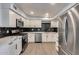 Modern kitchen with sleek white cabinetry, stainless steel appliances, and a stylish backsplash at 148 N Glenview --, Mesa, AZ 85213