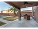 Inviting covered back patio features a ceiling fan and built-in BBQ area for outdoor entertaining at 15466 W Shangri La Rd, Surprise, AZ 85379