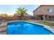 Sparkling pool is nestled in a private backyard, complete with mature palm trees at 15466 W Shangri La Rd, Surprise, AZ 85379