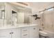 Bathroom with double sinks, white cabinets, modern fixtures, and a combined shower and tub at 15466 W Shangri La Rd, Surprise, AZ 85379