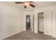 This bedroom has carpet, a ceiling fan, and a doorway that leads to another area at 15466 W Shangri La Rd, Surprise, AZ 85379