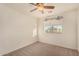 Bedroom features a ceiling fan, carpet flooring, and a window that provides natural light at 15466 W Shangri La Rd, Surprise, AZ 85379