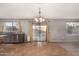 Open dining room with tile flooring, sliding glass doors, and chandelier at 15466 W Shangri La Rd, Surprise, AZ 85379