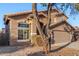 Charming two-story home with brown stucco, a tile roof and desert landscaping at 15466 W Shangri La Rd, Surprise, AZ 85379