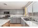 Well lit kitchen featuring gray cabinets, stainless steel appliances, and granite countertops at 15466 W Shangri La Rd, Surprise, AZ 85379