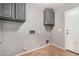 Functional laundry room with upper cabinets for storage and tile flooring at 15466 W Shangri La Rd, Surprise, AZ 85379